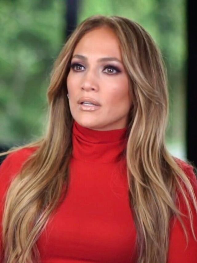 Photo by Capitalist Money on May 31, 2024. May be an image of Singer and actress Jennifer Lopez, with long highlighted hair, wearing a red turtleneck top. She appears to be listening intently to someone. .