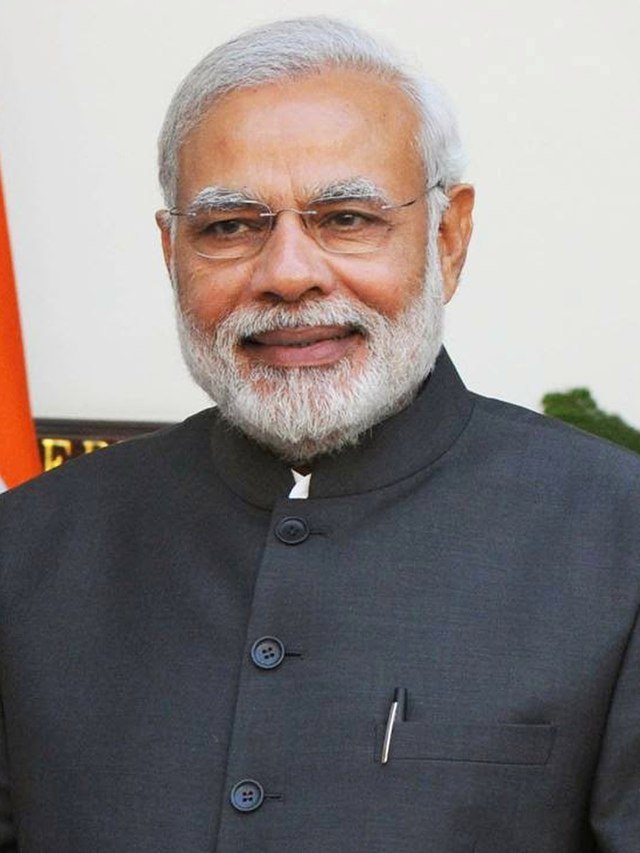 Photo by Capitalist Money on June 04, 2024. May be an image of A portrait of Narendra Modi, the Prime Minister of India, smiling in front of the Indian flag. .