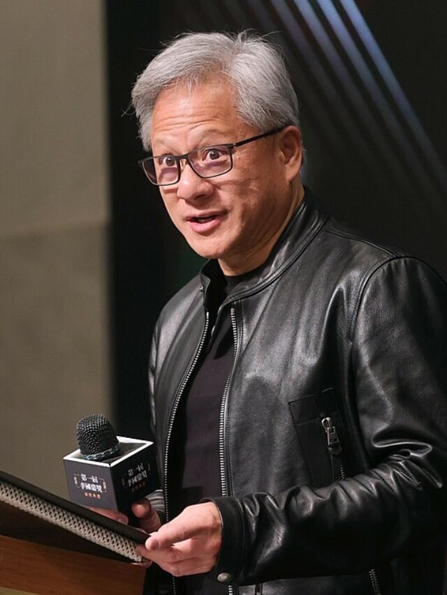 Photo by Capitalist Money on June 06, 2024. May be an image of A man with gray hair and glasses is speaking into a microphone. He is wearing a black leather jacket and a black shirt. He is holding a plaque in his left hand. .