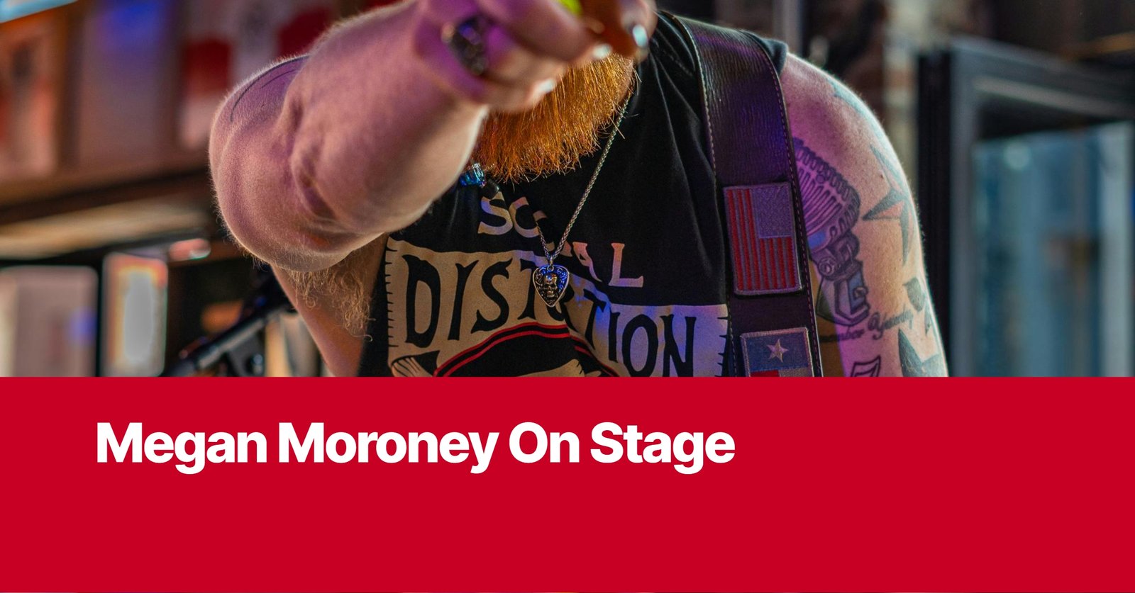 Photo by Capitalist Money on September 10, 2024. May be an image of A close up photo of a man with a red beard, wearing a black tank top with a skull necklace, while he is on stage. The image may contain text such as 'Megan Moroney On Stage'.