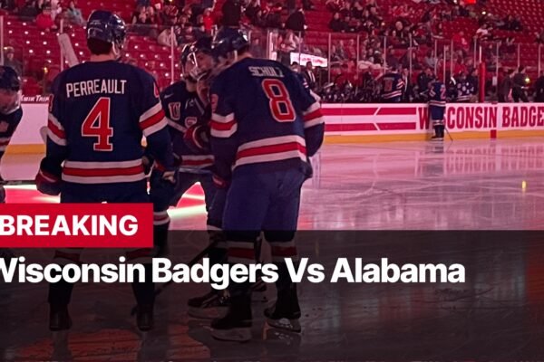 Photo by Capitalist Money on September 08, 2024. May be an image of The Wisconsin Badgers hockey team is on the ice, with a player wearing number 4 in focus. A red banner behind them reads "Wisconsin Badgers". The team appears to be celebrating a goal. The image may contain text such as 'BREAKING', 'Wisconsin Badgers Vs Alabama'.