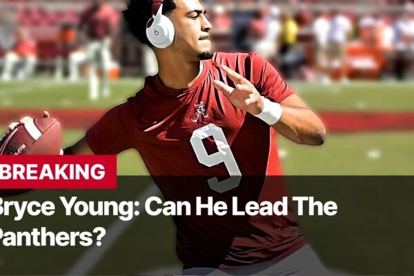 Photo by Capitalist Money on September 09, 2024. May be an image of Bryce Young, the quarterback for the Carolina Panthers, is pictured in a red jersey with the number 9. He is holding a football and looking intently. The image may contain text such as 'BREAKING', 'Bryce Young: Can He Lead The', 'Panthers?'.