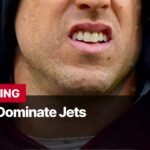 Photo by Capitalist Money on September 10, 2024. May be an image of A close-up shot of a man's face, with a red jacket, and the text "BREAKING 49ers Dominate Jets" below. The image may contain text such as 'B', 'R', 'E', 'A', 'K', 'I', 'N', 'G', ' ', '4', '9', 'e', 'r', 's', ' ', 'D', 'o', 'm', 'i', 'n', 'a', 't', 'e', ' ', 'J', 'e', 't', 's'.