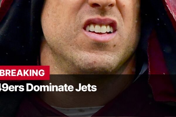 Photo by Capitalist Money on September 10, 2024. May be an image of A close-up shot of a man's face, with a red jacket, and the text "BREAKING 49ers Dominate Jets" below. The image may contain text such as 'B', 'R', 'E', 'A', 'K', 'I', 'N', 'G', ' ', '4', '9', 'e', 'r', 's', ' ', 'D', 'o', 'm', 'i', 'n', 'a', 't', 'e', ' ', 'J', 'e', 't', 's'.