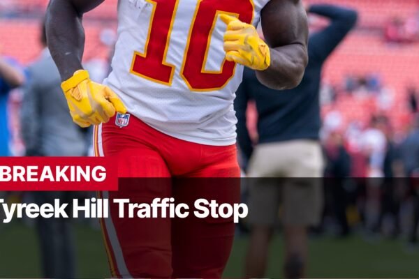 Photo by Capitalist Money on September 11, 2024. May be an image of A close-up photo of Tyreek Hill wearing a Kansas City Chiefs uniform, standing on a football field. He is wearing a yellow glove, and the photo has a black and red overlay with the words "BREAKING" and "Tyreek Hill Traffic Stop". The image may contain text such as 'BREAKING', 'Tyreek Hill Traffic Stop'.