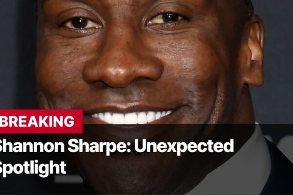 Photo by Capitalist Money on September 12, 2024. May be an image of A close-up image of Shannon Sharpe smiling with his teeth showing. The image is cropped to just show his face with the words "BREAKING Shannon Sharpe: Unexpected Spotlight" written on a red banner across the bottom of the image. The image may contain text such as 'B', 'R', 'E', 'A', 'K', 'I', 'N', 'G', ' ', 'S', 'h', 'a', 'n', 'n', 'o', 'n', ' ', 'S', 'h', 'a', 'r', 'p', 'e', ':', ' ', 'U', 'n', 'e', 'x', 'p', 'e', 'c', 't', 'e', 'd', ' ', 'S', 'p', 'o', 't', 'l', 'i', 'g', 'h', 't'.