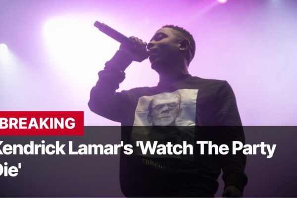 Photo by Capitalist Money on September 12, 2024. May be an image of Kendrick Lamar performs on stage, singing into a microphone. He is wearing a black sweatshirt with a white image on it. The background is purple and there are spotlights shining down. The image may contain text such as 'BREAKING', 'Kendrick Lamar's 'Watch The Party', 'Die''.