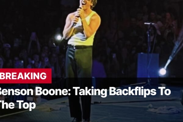 Photo by Capitalist Money on September 13, 2024. May be an image of Singer Benson Boone performs on stage in front of a cheering crowd. The image may contain text such as 'BREAKING', 'Benson Boone: Taking Backflips To', 'The Top'.