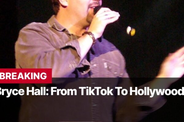 Photo by Capitalist Money on September 14, 2024. May be an image of A man with short brown hair is speaking into a microphone. He is wearing a grey button up shirt. The background is black with white text that says "BREAKING Bryce Hall: From TikTok To Hollywood". The image may contain text such as 'B', 'R', 'E', 'A', 'K', 'I', 'N', 'G', ' ', 'B', 'r', 'y', 'c', 'e', ' ', 'H', 'a', 'l', 'l', ':', ' ', 'F', 'r', 'o', 'm', ' ', 'T', 'i', 'k', 'T', 'o', 'k', ' ', 'T', 'o', ' ', 'H', 'o', 'l', 'l', 'y', 'w', 'o', 'o', 'd'.