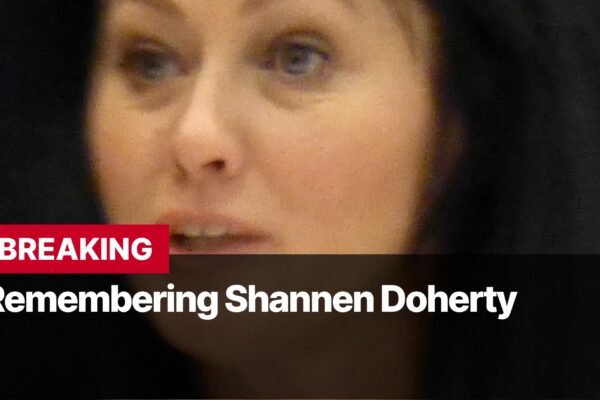 Photo by Capitalist Money on September 16, 2024. May be an image of A woman with dark hair looks into the camera. She is speaking. The text above her says "BREAKING Remembering Shannen Doherty." The image may contain text such as 'B', 'R', 'E', 'A', 'K', 'I', 'N', 'G', ' ', 'R', 'e', 'm', 'e', 'm', 'b', 'e', 'r', 'i', 'n', 'g', ' ', 'S', 'h', 'a', 'n', 'n', 'e', 'n', ' ', 'D', 'o', 'h', 'e', 'r', 't', 'y'.