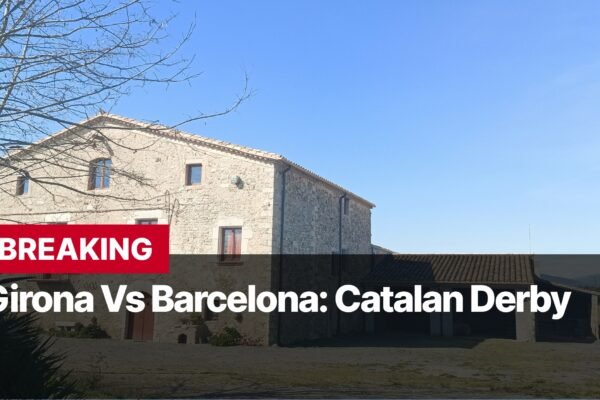 Photo by Capitalist Money on September 16, 2024. May be an image of A stone building with a tiled roof sits in a rural setting. The sky is blue and there are some trees in the background. There is a sign that reads "BREAKING Girona Vs Barcelona: Catalan Derby". The image may contain text such as 'BREAKING', 'Girona Vs Barcelona: Catalan Derby'.