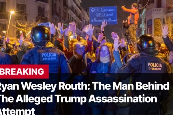 Photo by Capitalist Money on September 17, 2024. May be an image of A crowd of people are protesting, with some raising their hands in the air. There are police officers in riot gear standing in front of the crowd. The text "BREAKING" and "Ryan Wesley Routh: The Man Behind The Alleged Trump Assassination Attempt" is superimposed over the image. The image may contain text such as 'BREAKING', 'Ryan Wesley Routh: The Man Behind The Alleged Trump Assassination Attempt', 'POLICIA', 'D100A6289', 'POLICIA', 'D114A2756', 'POLICIA', 'D100A6207', '@EU_Commission', '@EUCouncil', '#FreePoliticalPrisoners'.