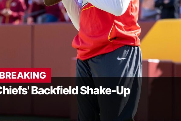 Photo by Capitalist Money on September 17, 2024. May be an image of A football player in a red jersey and black pants stands on a field. The text "BREAKING" is displayed above a headline that reads "Chiefs' Backfield Shake-Up." The image may contain text such as 'B', 'R', 'E', 'A', 'K', 'I', 'N', 'G', ' ', 'C', 'h', 'i', 'e', 'f', 's', ''', ' ', 'B', 'a', 'c', 'k', 'f', 'i', 'e', 'l', 'd', ' ', 'S', 'h', 'a', 'k', 'e', '-', 'U', 'p'.