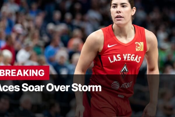 Photo by Capitalist Money on September 18, 2024. May be an image of A female basketball player wearing a red Las Vegas Aces jersey is shown in the image. She is walking onto the court with a determined look on her face. The Aces recently beat the Storm in a WNBA game and are headed to the playoffs. The image may contain text such as 'BREAKING Aces Soar Over Storm AT&T'.