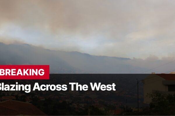 Photo by Capitalist Money on September 08, 2024. May be an image of A hazy sky with smoke billowing in the distance. The smoke is obscuring the view of the mountains in the background. The words "BREAKING" and "Blazing Across The West" are superimposed on the image, suggesting a wildfire is taking place. The image may contain text such as 'BREAKING', 'Blazing Across The West'.