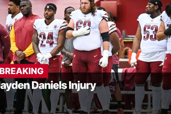 Photo by Capitalist Money on October 21, 2024. May be an image of The Washington Commanders players stand with heads bowed in prayer on the field, as news of a serious injury breaks. The image may contain text such as 'BREAKING Jayden Daniels Injury'.