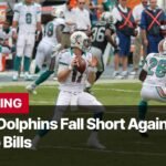 Photo by Capitalist Money on November 04, 2024. May be an image of A Miami Dolphins player prepares to throw the football during a game against the Buffalo Bills. The Bills appear to be winning. The image also features a referee wearing a black and white striped jersey. The image may contain text such as 'BREAKING Miami Dolphins Fall Short Against Buffalo Bills Image by Moe Epsilon'.