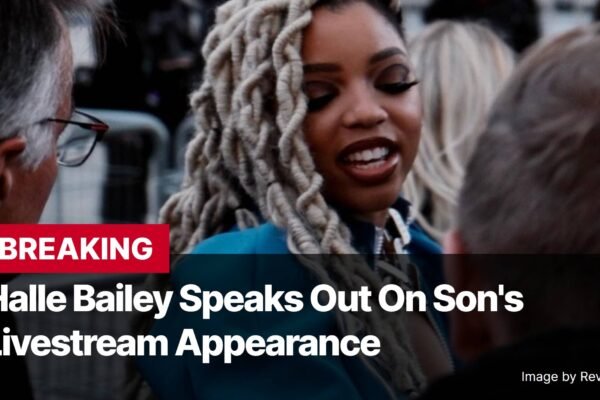 Photo by Capitalist Money on November 07, 2024. May be an image of Halle Bailey is seen smiling at a camera while wearing a blue shirt and sporting long white dreadlocks. The image may contain text such as 'B', 'R', 'E', 'A', 'K', 'I', 'N', 'G', ' ', 'H', 'a', 'l', 'l', 'e', ' ', 'B', 'a', 'i', 'l', 'e', 'y', ' ', 'S', 'p', 'e', 'a', 'k', 's', ' ', 'O', 'u', 't', ' ', 'O', 'n', ' ', 'S', 'o', 'n', ''', 's', ' ', 'L', 'i', 'v', 'e', 's', 't', 'r', 'e', 'a', 'm', ' ', 'A', 'p', 'p', 'e', 'a', 'r', 'a', 'n', 'c', 'e', ' ', 'I', 'm', 'a', 'g', 'e', ' ', 'b', 'y', ' ', 'R', 'e', 'v', 'e', 'n', 'g', 'e', 'r', 'T', 'i', 'm', 'e'.