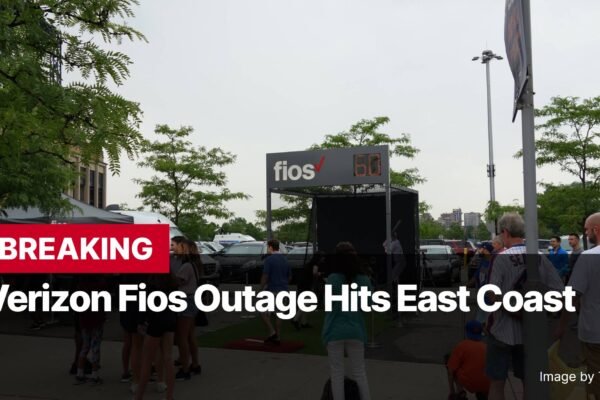 Photo by Capitalist Money on November 12, 2024. May be an image of A photo of a large sign that says "Verizon Fios Outage Hits East Coast" with a crowd of people standing around it in a parking lot. The image may contain text such as 'BREAKING', 'Verizon Fios Outage Hits East Coast', 'Test your speed at the Fios Fastball Challenge', 'Image by Tdorante10', 'fios'.