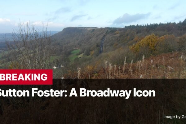 Photo by Capitalist Money on November 13, 2024. May be an image of A photo of a road winding through a wooded area in Sutton Foster. The image may contain text such as 'BREAKING', 'Sutton Foster: A Broadway Icon', 'Image by GeographBot'.