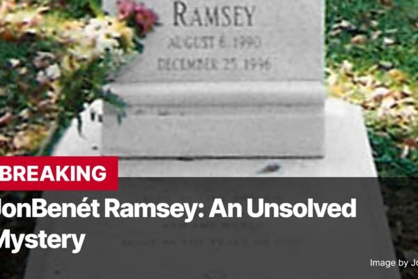 Photo by Capitalist Money on November 26, 2024. May be an image of A close-up shot of JonBenét Ramsey's grave, featuring a tombstone with her name and birth and death dates. Fresh flowers are placed at the base of the stone. The image is accompanied by text that reads 'BREAKING JonBenét Ramsey: An Unsolved Mystery.' The overall mood is somber and suggestive of an ongoing investigation. The image may contain text such as 'RAMSEY AUGUST 6, 1990 DECEMBER 25, 1996 BREAKING JonBenét Ramsey: An Unsolved Mystery Image by Jorgebarrios'.