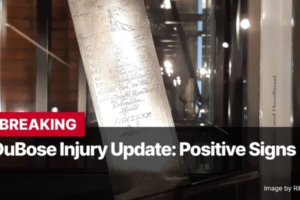 Photo by Capitalist Money on December 16, 2024. May be an image of Close-up view of an antique sword or dagger with intricate engravings on its blade, displayed in a glass case. The image is overlaid with text announcing a positive update on a DuBose injury. The image may contain text such as 'BREAKING', 'DuBose Injury Update: Positive Signs', 'Leib- und Handfessel.', 'Image by Rikki Mitterer', 'IDCLXXX'.