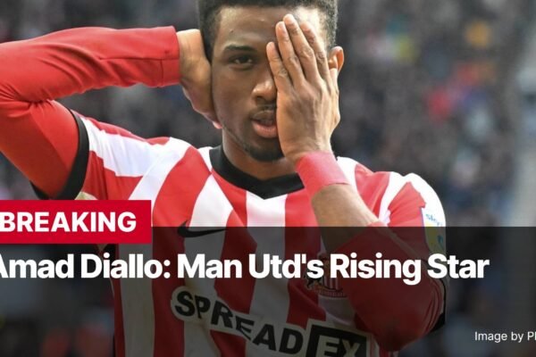 Photo by Capitalist Money on December 16, 2024. May be an image of Amad Diallo, the rising star of Manchester United, is pictured in a red and white striped jersey, his hand covering one eye. The image conveys a sense of contemplation or perhaps disappointment. The image may contain text such as 'BREAKING Amad Diallo: Man Utd's Rising Star Image by PhongDuckk'.